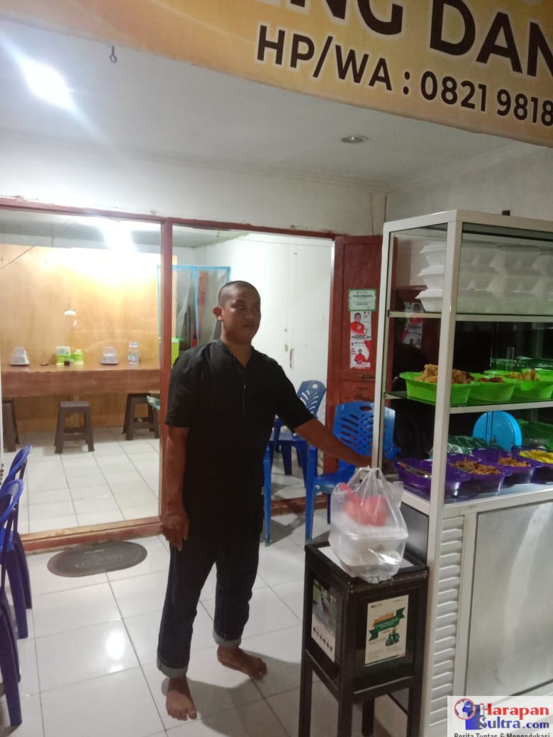 Akhsan Dahlan Saat Melayani Pelanggan nya Di Malam Hari.